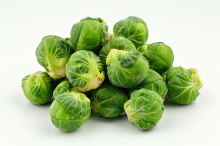 A pile of green broccoli with some of them being cut off. The pile is on a white backgroundの素材
