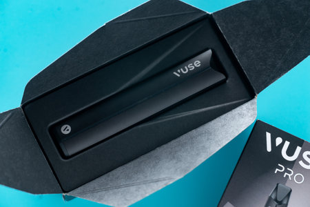 Caen, France - March 18, 2024: A vape and a box of vape juice sit on a blue surface. The box is labeled with the brand name VUSE Proのeditorial素材