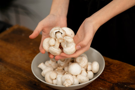 Culinary preparation with white mushrooms, kitchen scene.の写真素材