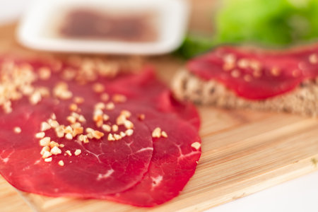 A piece of meat with nuts on top of itの写真素材