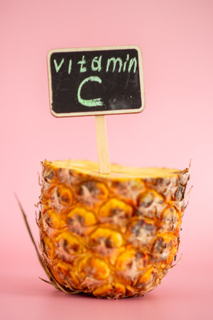 A pineapple with a sign that says vitamin C on itの写真素材