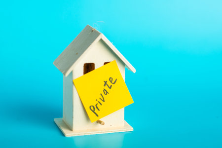 Small wooden house with private sign on vibrant blue background.の写真素材
