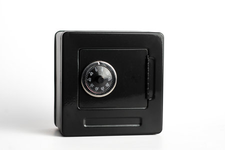 Black safe with combination lock on white background for security solutions.