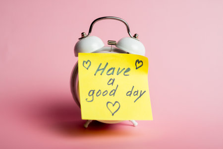 Cheerful yellow reminder on alarm clock for a positive morning boost.の写真素材