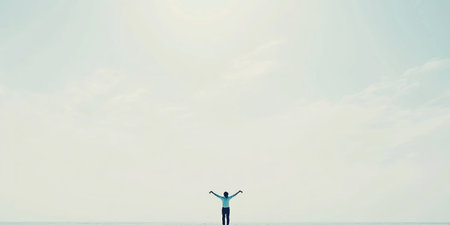 Solitary figure covering vast horizon under serene sky.の素材