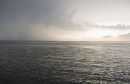 the lowering gray sky at the seaの写真素材