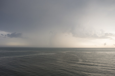 the lowering gray sky at the seaの写真素材