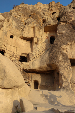 Ancient times people carved out homes in the fairy chimney rock formations in Cappadocia, Turkey. For it's unique geological formations, it's an popular travel destination in Turkey.の写真素材