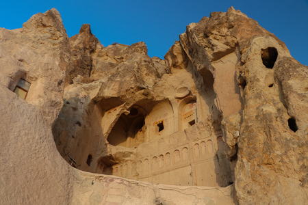 Ancient times people carved out homes in the fairy chimney rock formations in Cappadocia, Turkey. For it's unique geological formations, it's an popular travel destination in Turkey.の写真素材