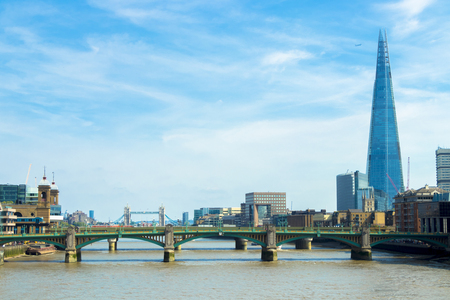 Cannon Street Railway Bridge and the Shard in London,UK at sunset as seen from the North bank of river Thames.のeditorial素材