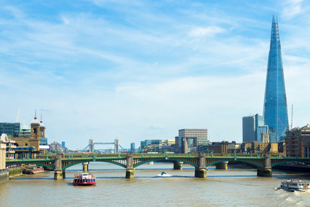 London, United Kingdom - August 28, 2017: Pleasure boat on the River Thames against the backdrop of Cannon Street Railway Bridge and the skyscraper Shard, London, UKのeditorial素材