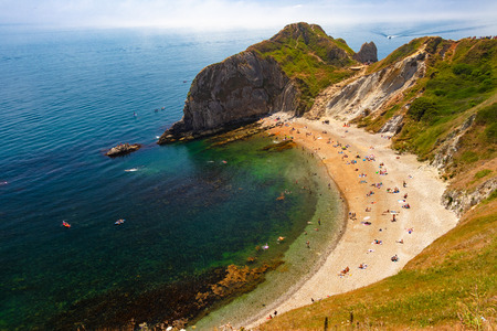 Dorset, United Kingdom- July 14, 2018: Man of War Bay encloses Man O'War Cove on the Dorset coast in southern England, between the headlands of Durdle Door to the west and Man O War Head to the east.のeditorial素材