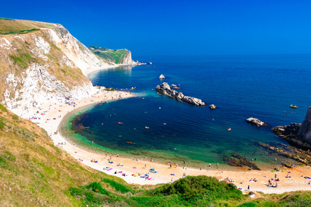 Dorset, United Kingdom- July 14, 2018: Man of War Bay encloses Man O'War Cove on the Dorset coast in...