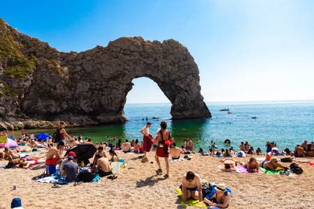 Dorset, United Kingdom- July 14, 2018: Tourists Relaxing On Durdle Door Beach, Dorset; Summer Time English Heat Wave 2018のeditorial素材