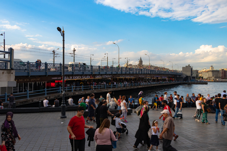 Istanbul, Turkey - September 6, 2018: Galata Bridge with traditional fish restaurants in the passage under the bridge overlooking Galata Tower in the far distance.のeditorial素材