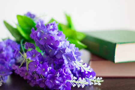 Books with flowers on a wood table.の写真素材