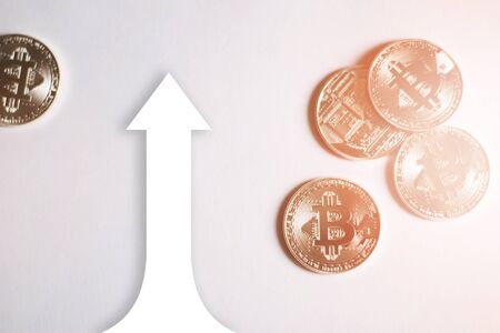 Bitcoins on a white background. A concept from coins of the cryptocurrency.  Graphics growth rate bitcoin.の写真素材