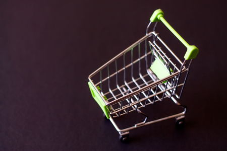 Empty shopping cart on a black background. The concept of shopping in the supermarket.の写真素材