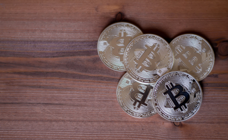 Bitcoins on a wooden background. A concept from coins of the cryptocurrency.の写真素材