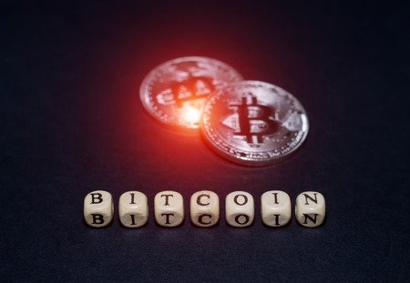 Crypto currency is bitcoin. Coins and cubes with letters on a black background.の写真素材