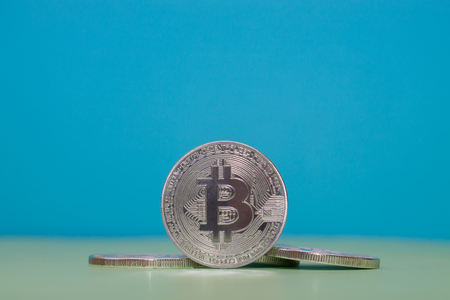 Bitcoin on a green background. Metal coin, crypto currency.の写真素材