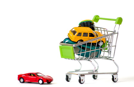RUSSIA, TYUMEN - NOVEMBER 28, 2017: Shopping cart with cars on a isolated background. Little toy cars in shop trolley.のeditorial素材