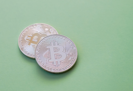 Bitcoin on a green background. Metal coin, crypto currency.の写真素材