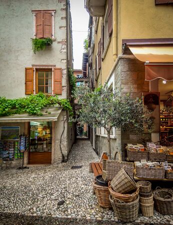 Beautiful italian alley and shops in Malcesine, Italy.の写真素材