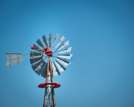 Antique texan farm windmill with clear sky on a sunny dayの写真素材