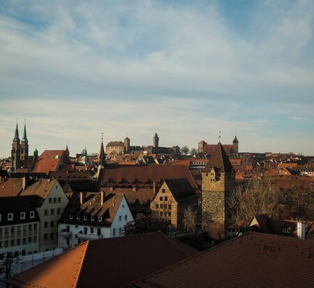 Aerial view of Nuremberg city with rooftops and medieval old castle towers and churches. Classical german architecture. Afternoon shot with copyspace available.の写真素材