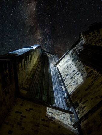 Upwards shot of Teyn church in Pragues historic old town. Long exposure at night with stars visible, no people visible. Architecture, straight lines. Copyspace.の写真素材