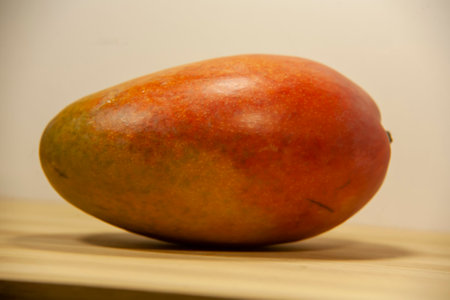 Mango fruit on a wooden table. Close-up, selective focus.の写真素材