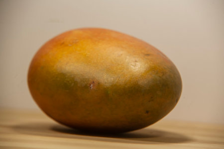 Mango fruit on a wooden table, studio shot, close upの写真素材