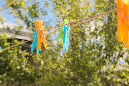 Coloured plastic pegs on the clothes line in Australian summer