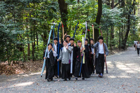 March 2018 - Meiji Jingu Shrine, Tokyo, Japan: Teenagers carrying their Kyudo archery bowsのeditorial素材