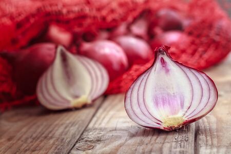 Close-up of red onion half on rustic wooden tableの写真素材