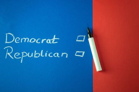 Democrat and Republican and checkboxes written with chalk on red and blue background. Copy spaceの写真素材