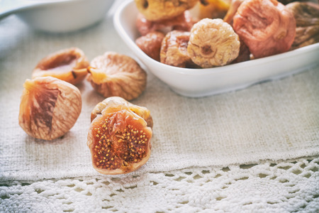 Dried figs in white bowl on tableの写真素材