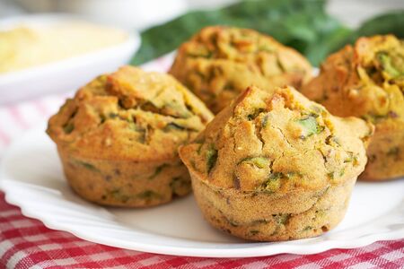 Vegan muffins with spinach and corn flour served on white plateの写真素材