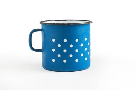 Old blue enamel cup with white dots isolated on white backgroundの写真素材