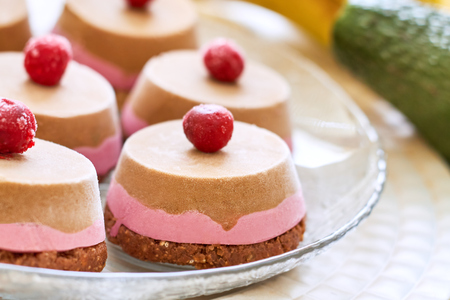 Raw vegan dessert with sour cherry served on glass plateの写真素材