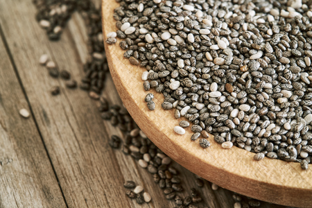 Chia seeds in wooden bowl on rustic background. Copy spaceの写真素材