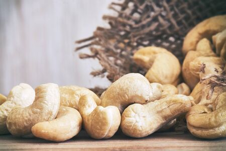 Closeup of cashew nuts with burlap sack in background. Copy spaceの写真素材