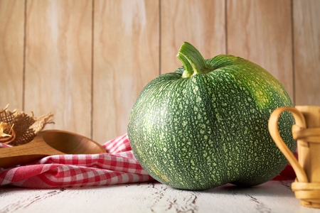 Round zucchini (courgette) summer squash on wooden background. Copy spaceの写真素材