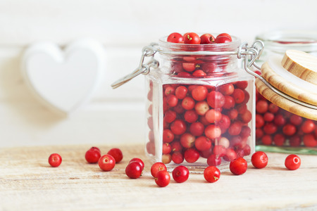 Fresh ripe cranberries in glass jar. Copy space の写真素材