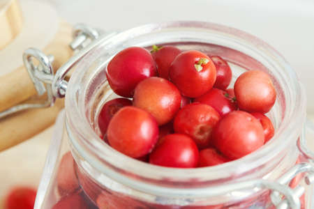 Closeup of fresh ripe cranberries in glass jarの写真素材