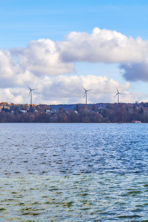 Wind turbines above Lake Starnberg on a sunny dayの写真素材