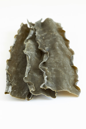 Dried kombu seaweed (Laminariaceae longissima) isolated on white backgroundの写真素材