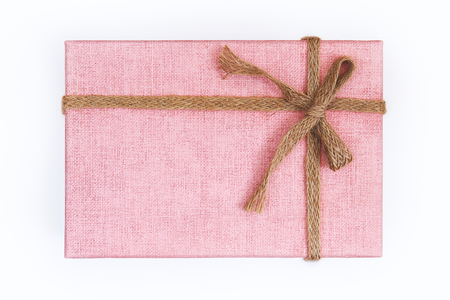 Pink gift box with burlap ribbon and bow isolated on white background. Top viewの写真素材