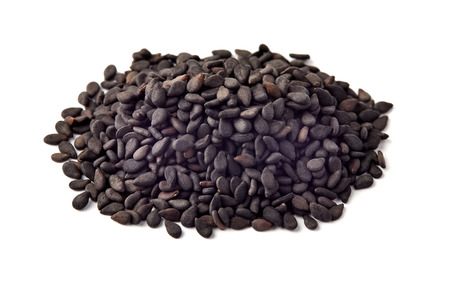 Pile of black sesame seeds isolated on white backgroundの写真素材